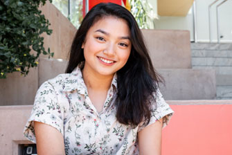 Female student sitting stairs campus