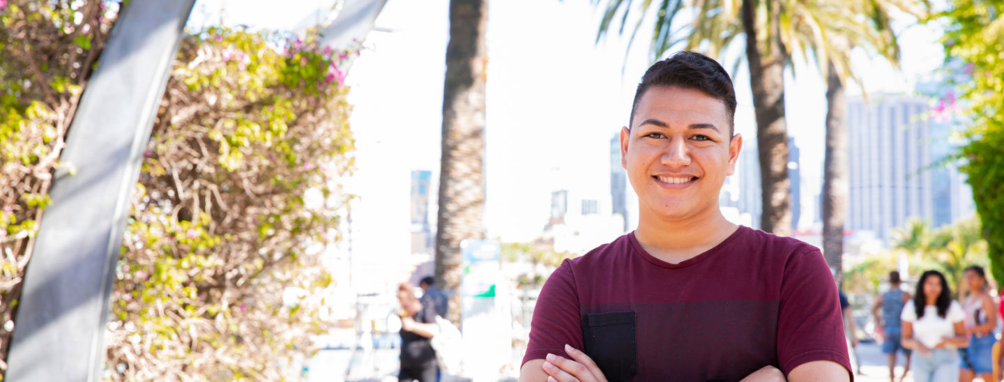 Male student outside happy