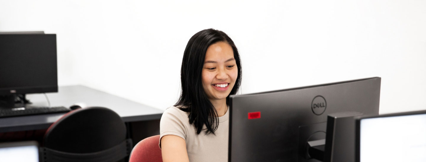 Student inside studying working computer