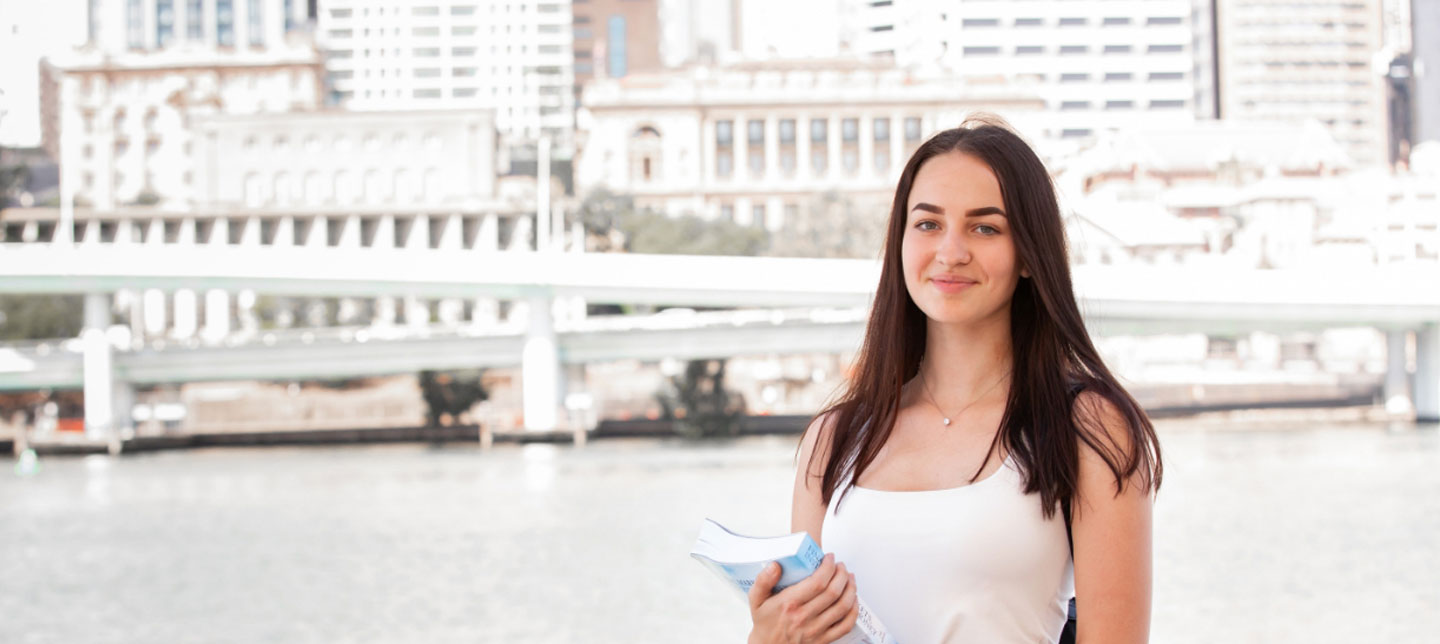 Student outside brisbane river