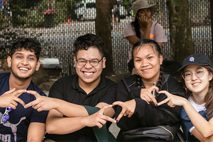 Students sitting outside happy together