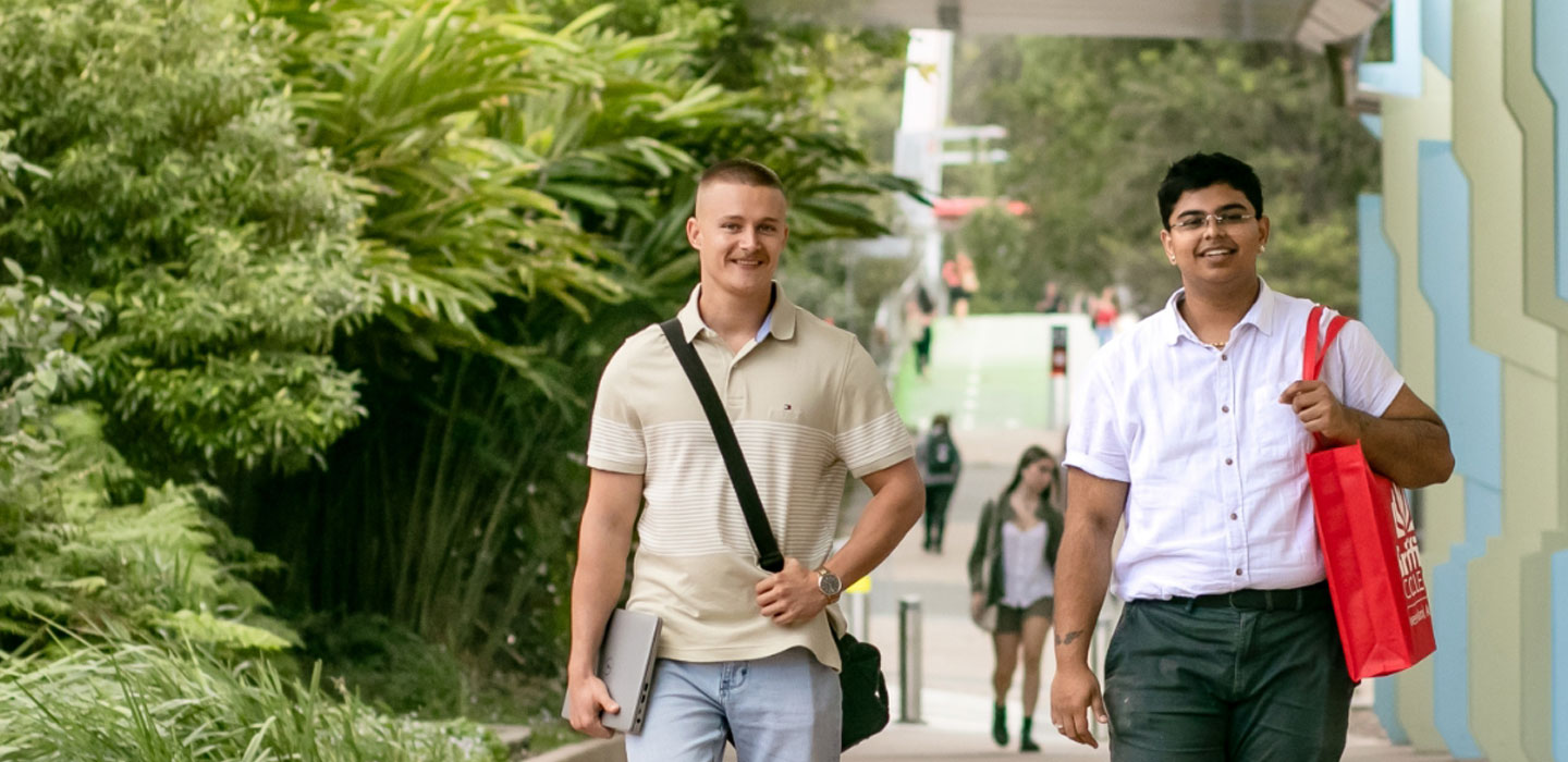 Students walking together campus smiling